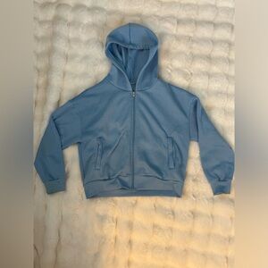 Woman’s light blue zip up hoodie